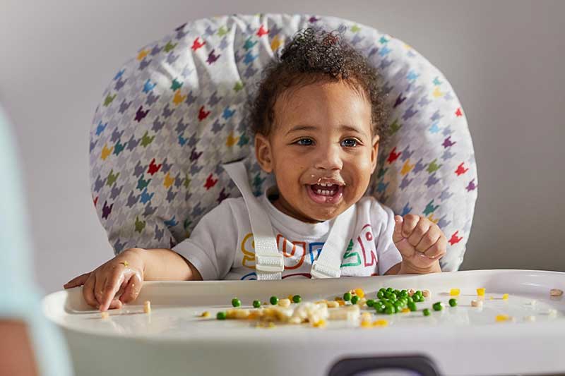 9 month old eating peas